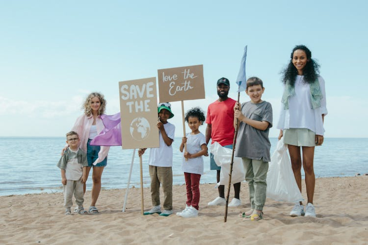 beach,children,diversity,environmental conservation,environmentalists,happy,kids,love the earth,people,placards,sand,save the earth,seaside,signs,smiling,standing,volunteers
