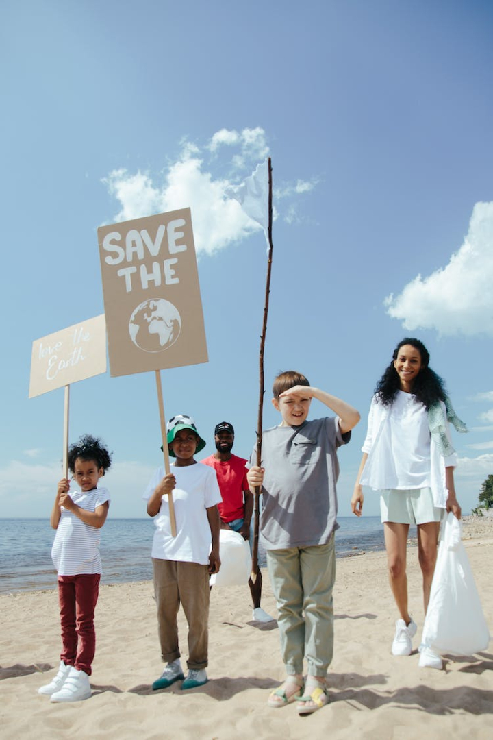 beach,children,diversity,environmental conservation,environmentalists,happy,kids,love the earth,people,placards,sand,save the earth,seaside,signs,smiling,standing,vertical shot,volunteers