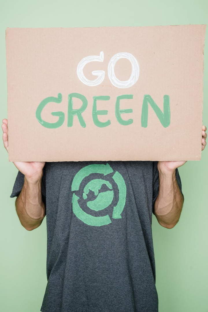 activist,adult,care,charity and relef work,chroma key,day,earth day,environmental conservation,environmentalist,front view,go green,green background,holding,man,obscured face,protection,sign,standing,studio shoot,sustainable lifestyle,text,volunteer