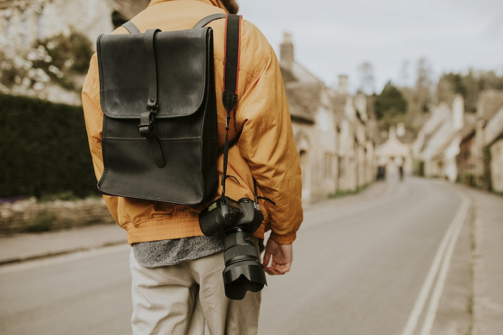 backpack,travel,camera strap,road,back,leather,walk,village,traveler man,tourist,walking,vacation,rawpixel