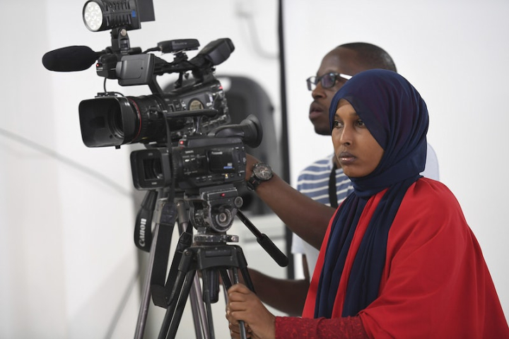 working people,camera,africa,behind the scene,video camera,press,somalia,profession,filming,video,women workers photos,working black women,rawpixel
