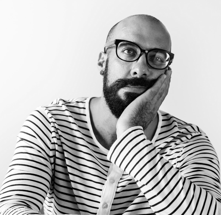 Closeup Portrait Of A Bearded Man With Hand On Face Stock Photo