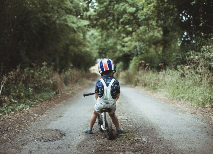bike,road,boy,childhood,stop,kid nature,biking,kid riding bike,people photos,safety,helmet,kid sitting,rawpixel