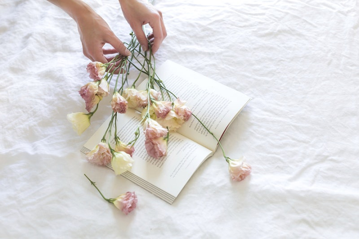 minimal,book,flat lay,white flower,bed,linen,woman,book flower,flower,minimal flower,flower  pink,hand flower,rawpixel