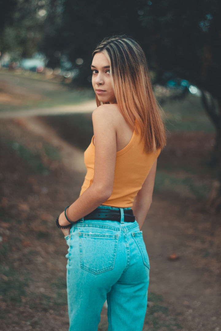 attractive,back view,beautiful,beauty,blur,casual,cute,denim jeans,depth of field,facial expression,fashion,female,focus,girl,glamour,hair,jeans,looking,model,outdoors,person,photoshoot,pose,posing,posture,pretty,sexy,tank top,wear