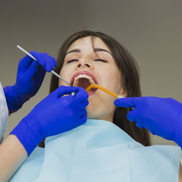 practitioner,orthodontist,surgical gloves,getting,oral hygiene,dentists,squared,stomatology,surgical,oral,defocused,close up,procedure,surgeon,checked,technician,dentistry,hygiene,close,medic,gloves,up,patient,female,dentist,teeth,dental,medicine,health,woman