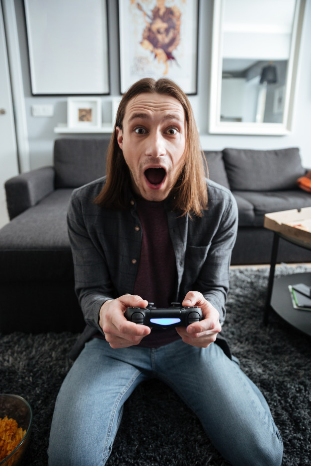 concentrated,pleased,indoors,enjoying,opened,joyful,shocked,concentration,leisure,videogame,looking,surprised,playing,adult,hobby,guy,joystick,positive,gamer,activity,sitting,gaming,young,screen,online,mouth,success,video,game,internet,happy,home,man,technology,people