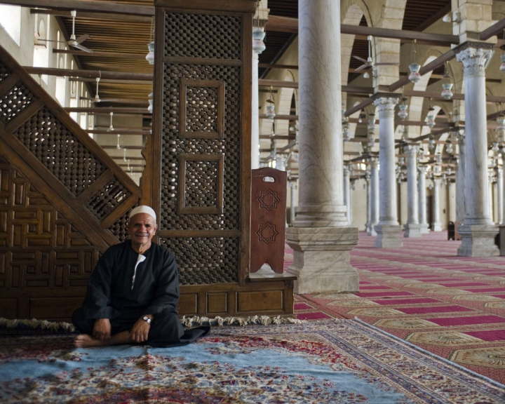adult,business,carpet,columns,egypt,egyptian,indoors,man,mosque,person,prayer,religion,sitting,wear,wood