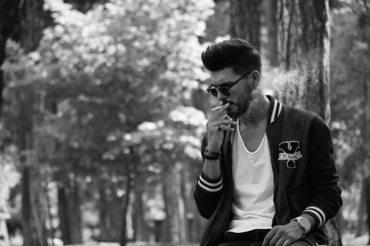 alone,black and white,casual wear,cigarette,good-looking,handsome,man,park,pensive,photoshoot,posing,sitting,smoke,smoking,sunglasses,thinking,trees