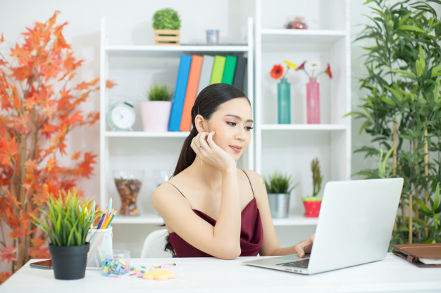 cheerful,businesswoman,positive,lifestyle,portrait,sitting,beautiful,asian,manager,young,female,working,lady,online,communication,person,internet,work,happy,smile,laptop,office,girl,woman,computer,technology,people,business