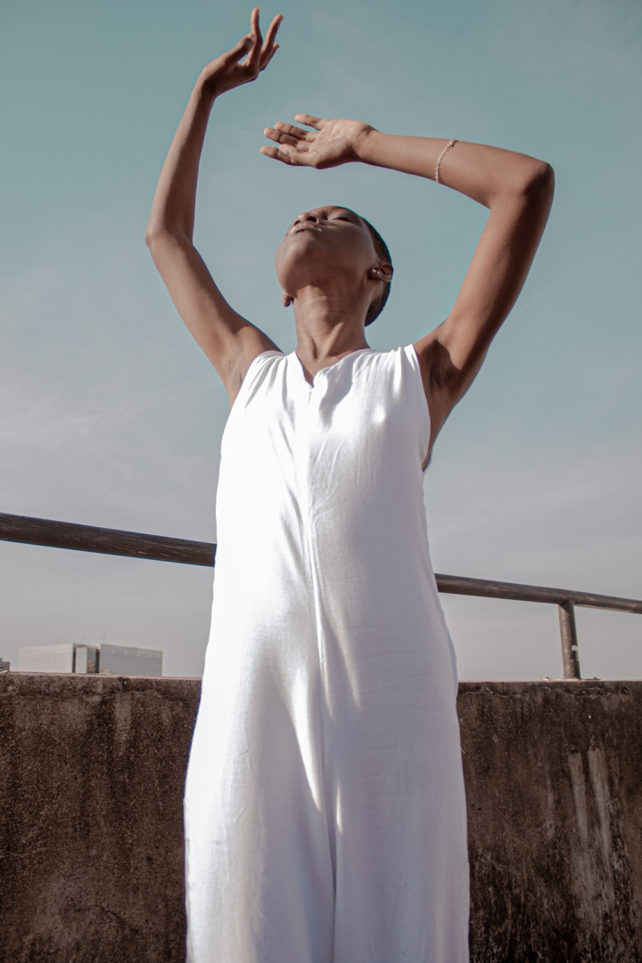 Free: Photo of Woman in White Dress Posing with Her Head up and