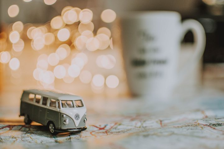 beverage,blur,close-up,coffee,coffee cup,depth of field,direction,drink,indoors,lights,map,toy car,volkswagen