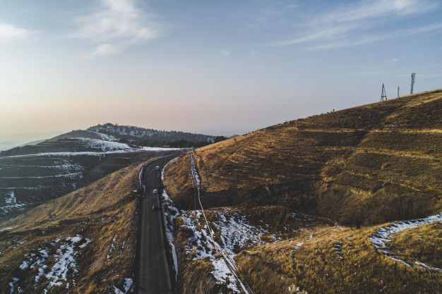 aerial winter,aerial road,birdseye,dolomite,roadway,aerial view,scenic,alpine,south,winding,alps,aerial,panorama,destination,snowy,rural,countryside,hills,peak,season,view,drone,outdoor,trip,cold,pine,curve,adventure,eye,landscape,road,mountain,wood,snow,winter