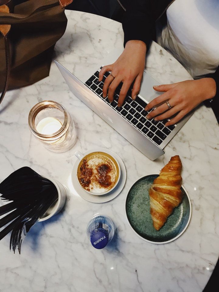 bread,coffee,croissant,drink,food,hands,laptop,typing