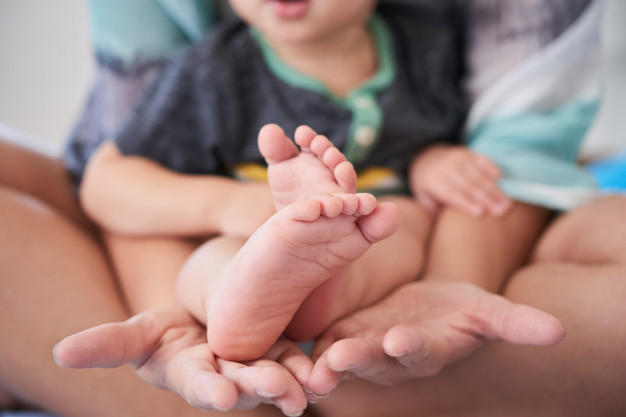 maternal,ethnicity,barefoot,motherhood,little,son,indoor,leisure,childhood,parent,feet,together,care,foot,boy,child,mother,cute,woman,family,hand,love,people