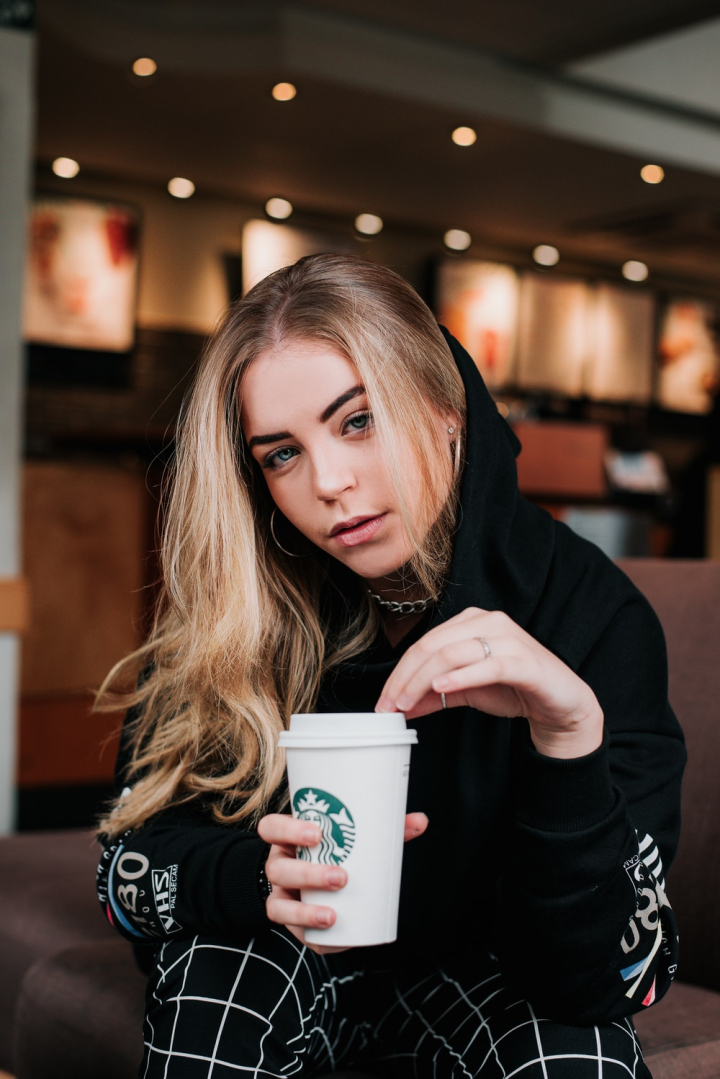 beautiful woman,beverage,brunette,caffeine,cappuccino,casual wear,close-up,coffee,coffee drink,coffee to go,cup of coffee,holding,hot drink,photoshoot,posing,pretty,sitting,starbucks,woman
