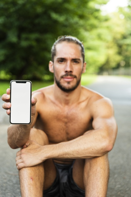 medium shot,front view,medium,exercising,outside,sporty,mock,front,athletic,outdoors,shot,holding,blank,male,athlete,up,sitting,view,runner,training,exercise,healthy,park,white,health,sport,man,phone,green,mockup