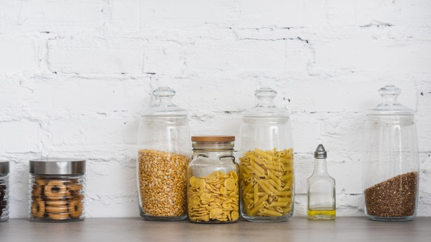 Food Ingredients In Glass Jars On A Kitchen Counter Top. Stock