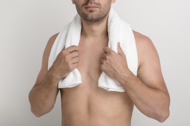 Woman covering bare chest with arms, close-up - Stock Photo