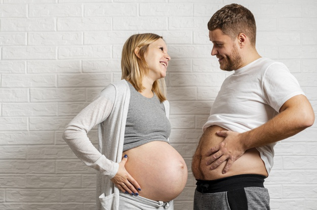 Free: Funny husband comparing his belly with pregnant wife Free Photo -  