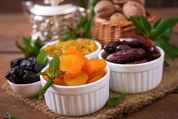 Dried figs, dried apricots and prunes in a mix with almonds in a