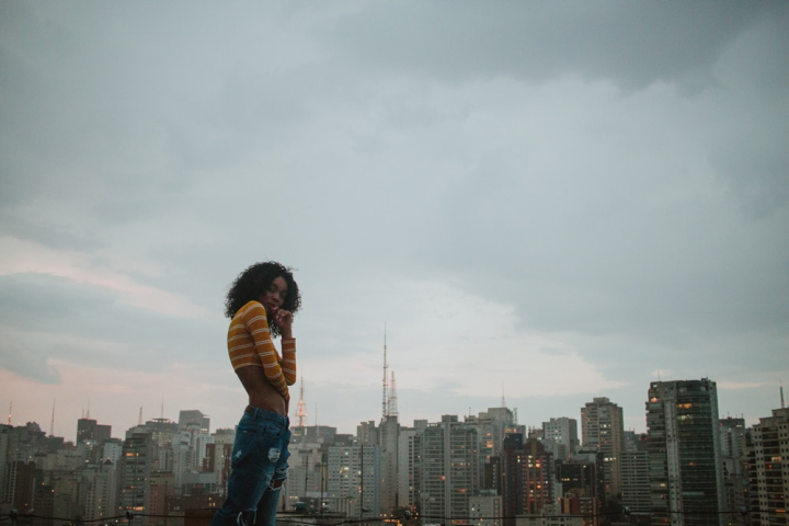 A Beautiful Woman Wearing a Crop Top and Ripped Jeans · Free Stock