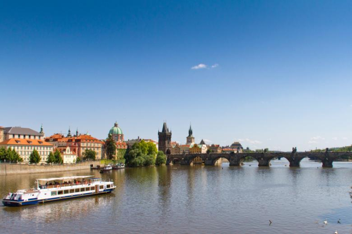 charles,bridge,prague,czech,outdoor,town,river,travel,view,day,destinations,urban,culture,old,famous,architecture,scenic,tourism,scene,water,tower,historical,stone,landmark,history,building,historic,most,reflection,city,blue,beauty,sky,construction,structure,gothic,europe,republic,cityscape,boats,netstockvault