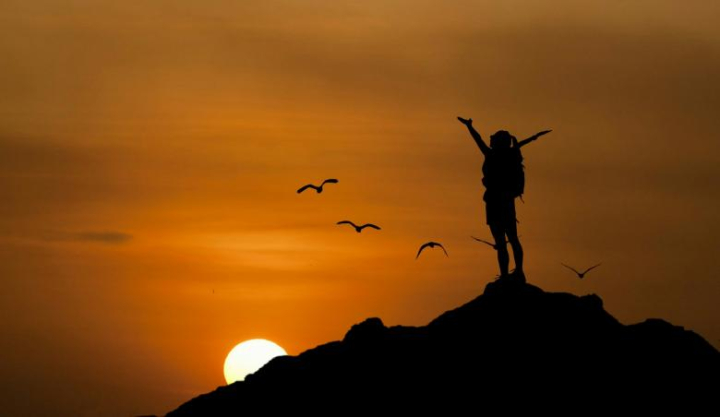 hiking,sunset,sun,birds,twilight,flying,freedom,person,top,rock,boulder,topview,outdoor,nature,sky,clouds,woman,panoramic,inspirational,evening,night,silhouette,netstockvault