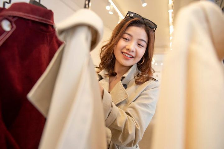 Free: A young happy beautiful woman is shopping in the clothing