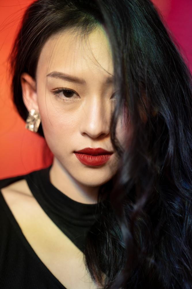 women,woman,young,asian,one,1,person,people,20s,girl,beauty,beautiful,red,background,looking at camera,light,sexy,mysterious,black,cutout top,artistic,fashion,sensuality,elegant,feminity,shiny,glamour,studio,models,indoor,cool,portrait,texture,refraction,illumination,glory,fashionable,earrings,accessories,makeup,cosmetics,lipstick,perfume,holographic,bright,cosmetology,front,hairdo,charming,hide,xframe