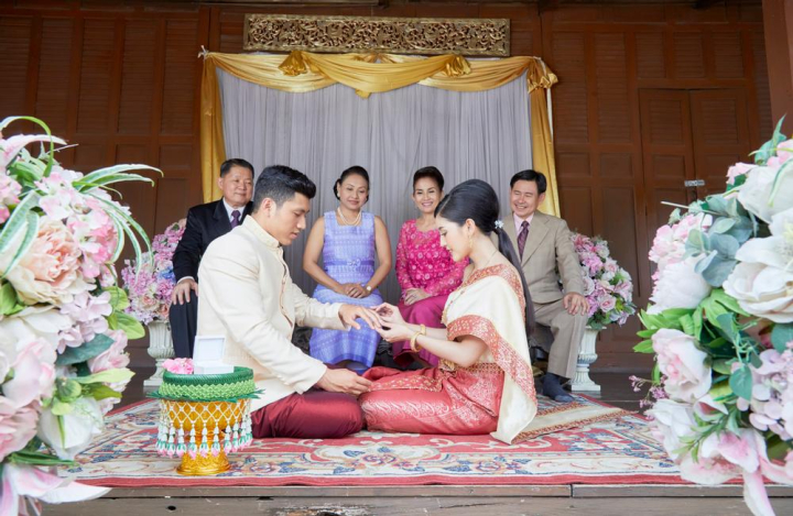 parents,looking,daughter,giving,wedding ring,husband,bride,groom,wedding,thai,thailand,blessing,celebration,marriage,traditional,thai style,married,bloom,jasmine,floral,flower,wife,happiness,setting,smile,decoration,dress,beautiful,elegant,elegance,together,culture,vintage,female,luxury,religion,religious,carpet,curtain,white,vases,sit,gold,women,men,man,male,ring,look,wedding date,honeymoon,handsome,love,anniversary,wood,outdoor,life event,joyful,delightful,children,mother,father,mother-in-law,father-in-law,cheers,traditional costume,spouse,son-in-law,daughter-in-law,black,pink,grey,red,necklace,bracelet,jewelry,asia,asian,happy,romantic,family,relatives,woman,aunt,couple,sacred,gratitude,buddhist,buddhism,arrangement,bridal,ceremony,engagement,guest,wedding reception,suit,khan maak,betel bowl,xframe