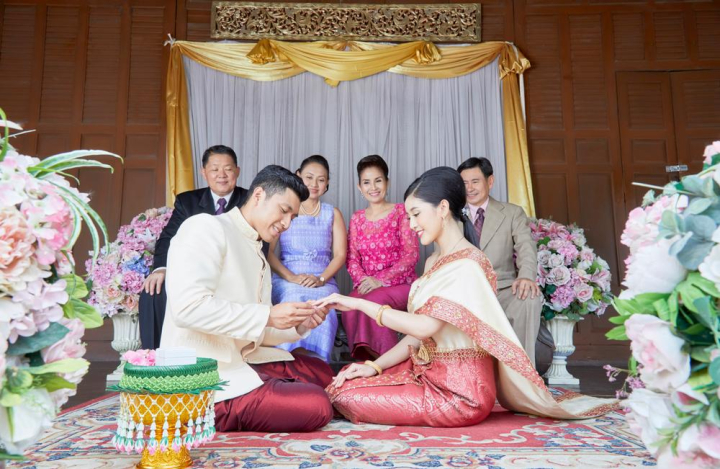 bride,groom,sitting,wearing,ring,finger,together,male,female,couple,love,jasmine,flower,pot,looking,smiling,engagement,group,man,woman,six,people,bridal,asia,asian,thai,religion,religious,sacred,dress,buddhist,buddhism,wedding,congratulation,thailand,thai style,family,relatives,husband,wife,beautiful,traditional,married,celebration,front,parents,decoration,hand,blessing,culture,floral,ceremony,happiness,elegant,vintage,mariage,khan maak,betel bowl,xframe