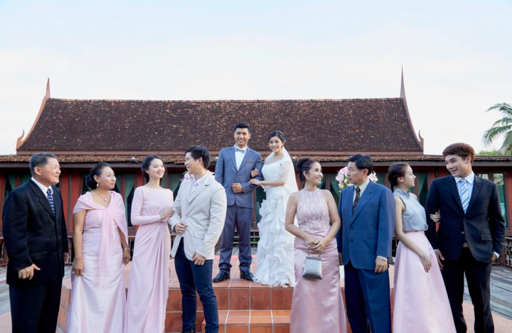 happy,newlyweds,wedding guests,posing,arm in arm,family,relatives,woman,female,women,man,men,male,aunt,couple,guest,asia,asian,congratulation,romantic,arrangement,bridal,bride,groom,married,jasmine,floral,flower,bloom,marriage,wedding,thai,thailand,blessing,wife,husband,dress,beautiful,elegant,elegance,together,wedding reception,garden wedding,wedding dress,suit,veil,congratulations,happiness,garden,restaurant,setting,smile,outdoor,life event,joyful,delightful,young,twenties,thirties,handsome,looking,xframe