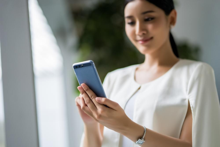 girl,holding,phone,using,calling,communication,online,connect,conversation,talking,attractive,success,elegant,professional,stand,watch,cheerful,joy,happiness,happy,female,woman,lady,business woman,employee,thai,thailand,asia,asian,tablet,smartphone,mobile,telephone,cellphone,call,technology,bright,brightness,break,worker,officer,alone,young,youth,beautiful,beauty,pretty,black hair,prettiness,twenties,thirties,portrait,company,work,xframe